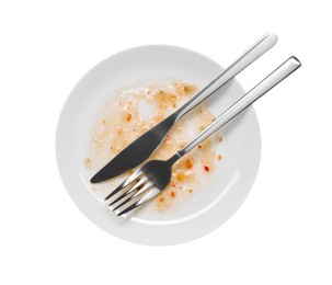 Dirty plate and cutlery on white background, top view