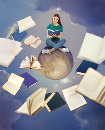 Image of Young woman sitting on moon and flying books