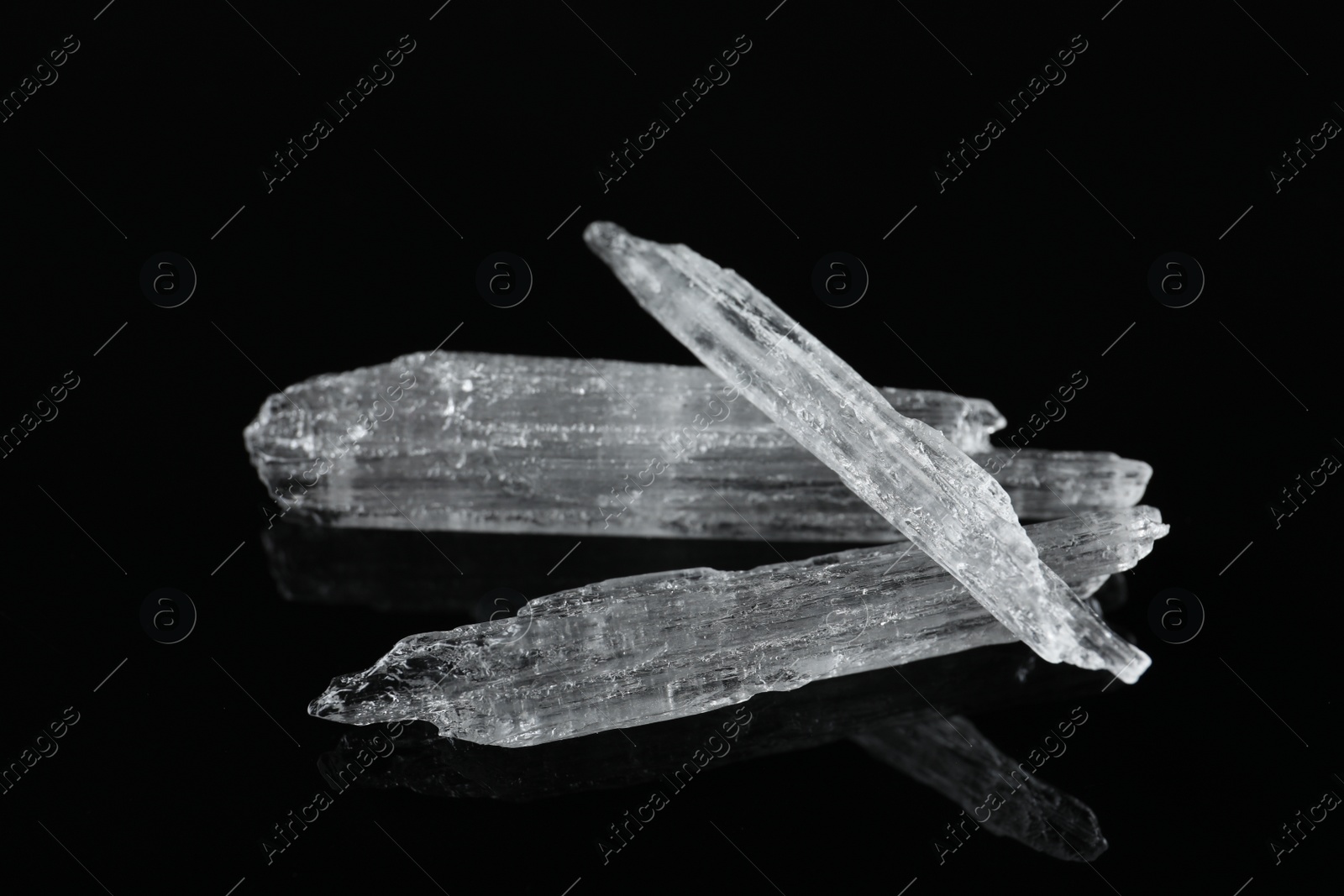 Photo of Menthol crystals on black background, closeup view