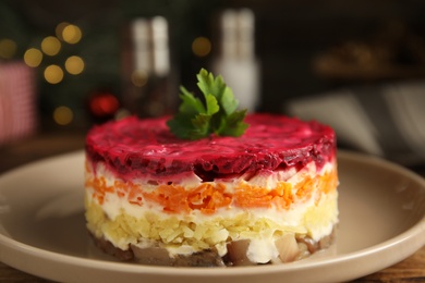 Photo of Herring under fur coat on plate, closeup. Traditional russian salad