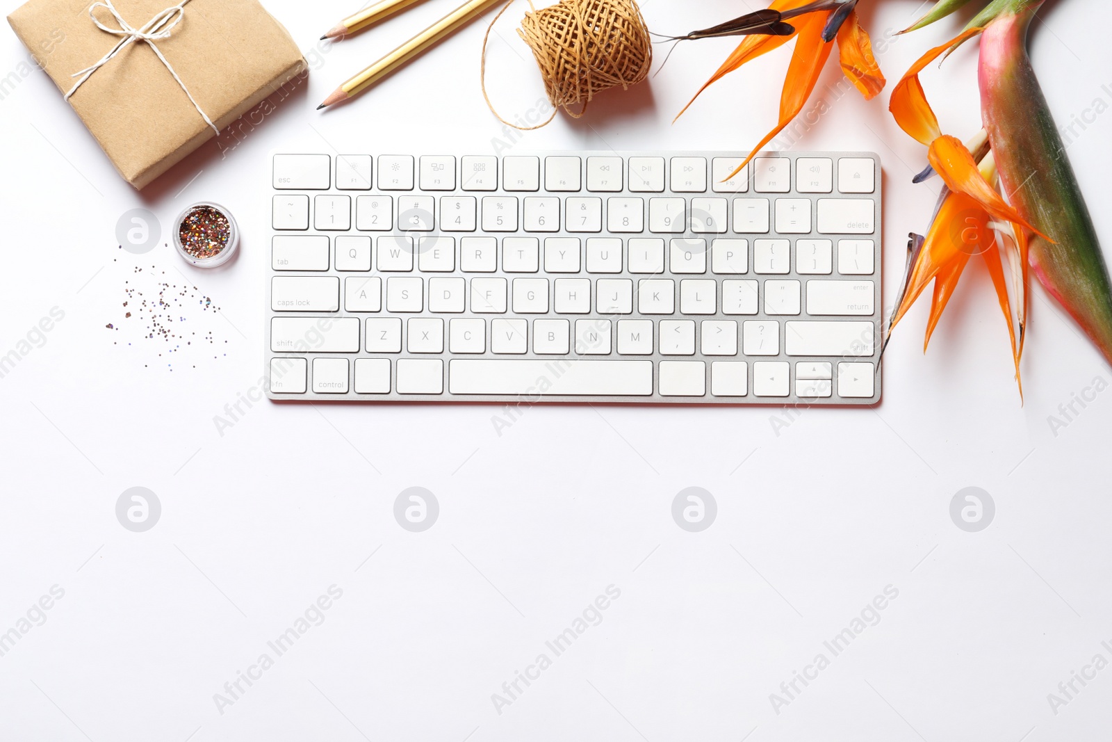 Photo of Creative flat lay composition with tropical flowers and computer keyboard on white background