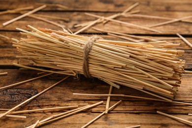 Sheaf of dried hay on wooden background, closeup