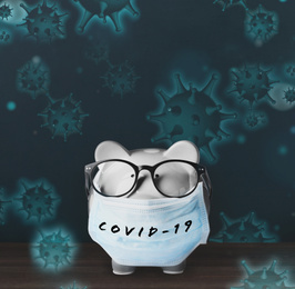 Piggy bank with medical mask. Money saving during coronavirus outbreak