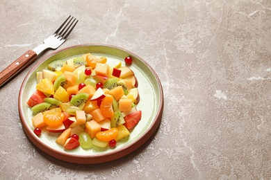 Photo of Plate with fresh cut fruits on table