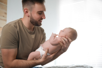 Father with his newborn son at home