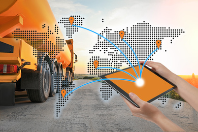 Image of Logistics concept. Woman using tablet with world map illustration against truck