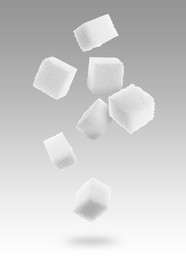 Refined sugar cubes in air on color gradient background