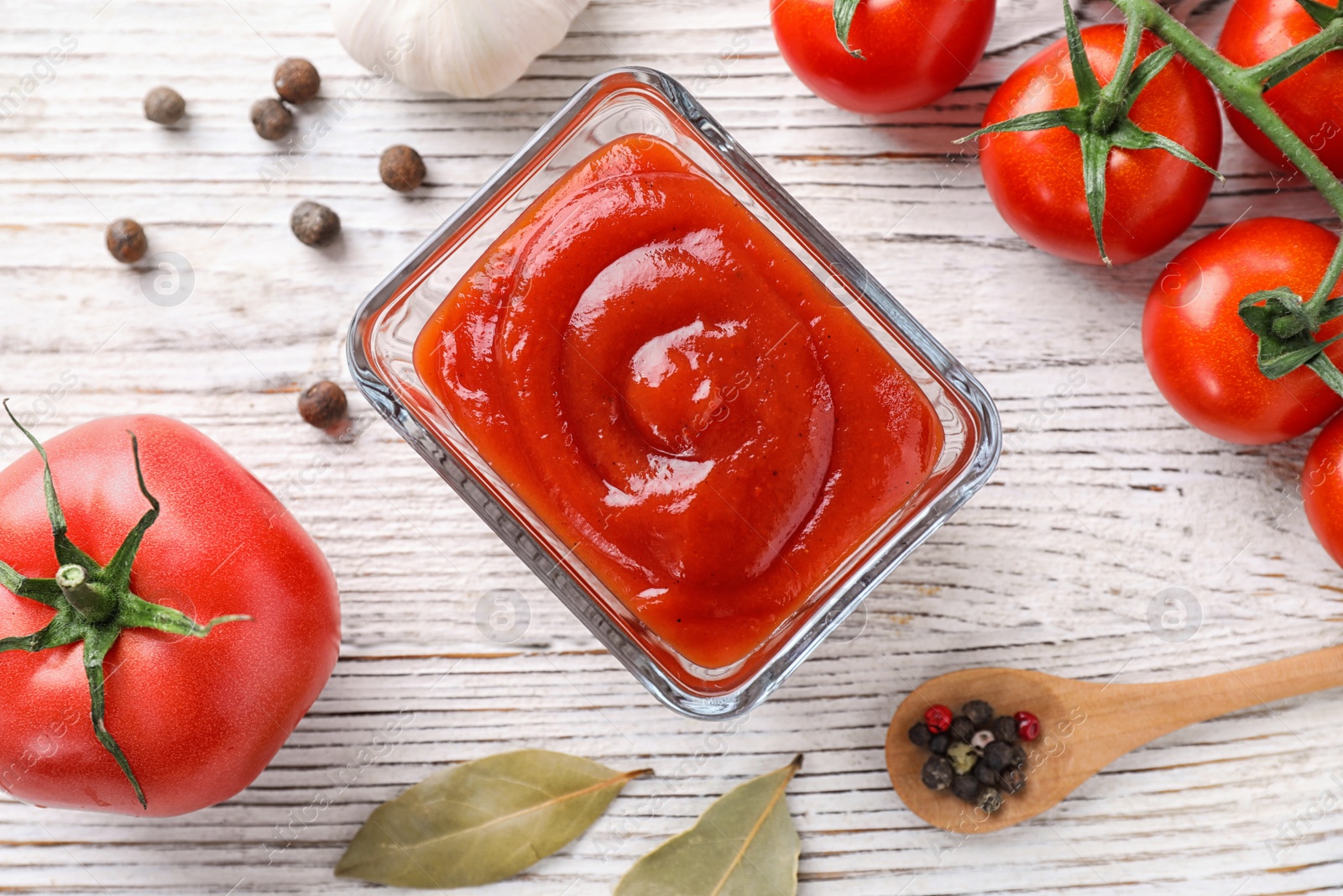 Photo of Flat lay composition with tomato sauce on white wooden table