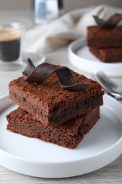 Photo of Delicious chocolate brownies on white table, closeup