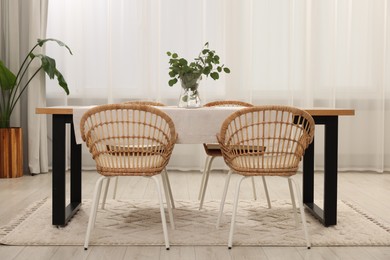 Photo of Stylish dining room with cozy furniture and plants