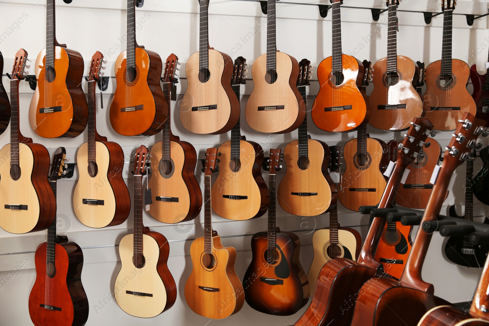 Photo of Rows of different guitars in music store