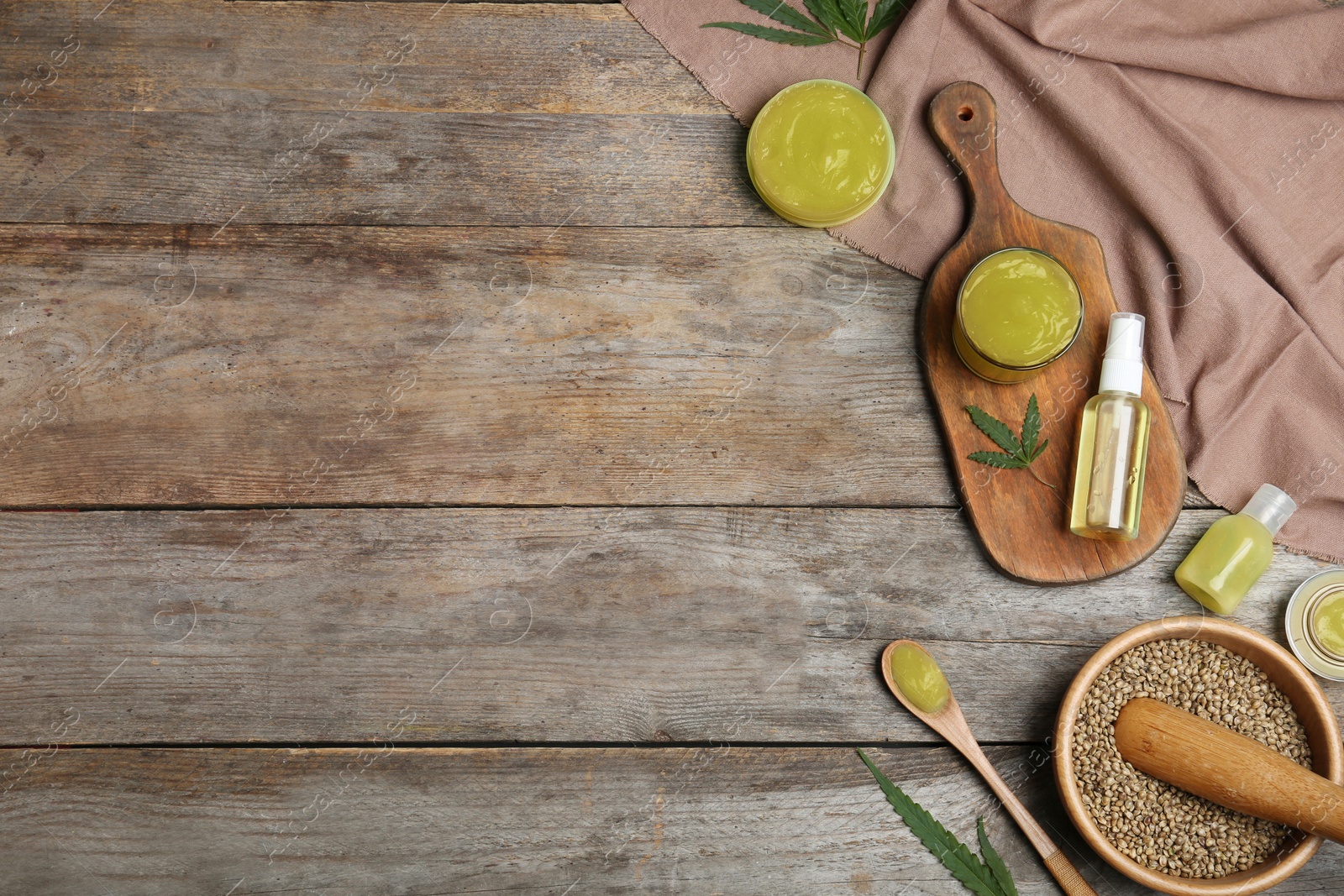 Photo of Flat lay composition with hemp lotion on wooden background