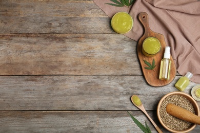 Photo of Flat lay composition with hemp lotion on wooden background