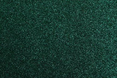 Photo of Shiny dark green glitter as background, closeup