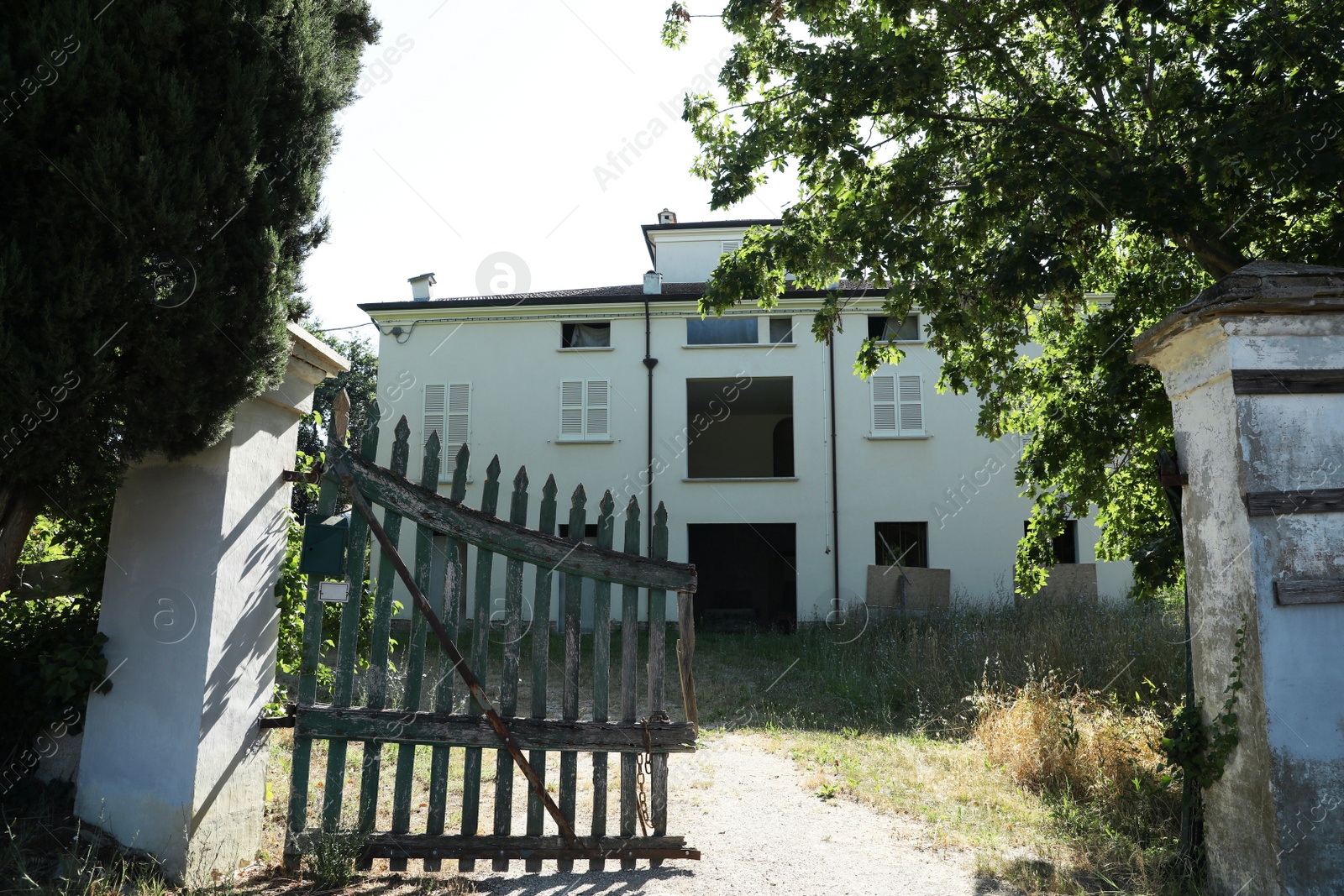 Photo of Residential building and old wooden fence on sunny day