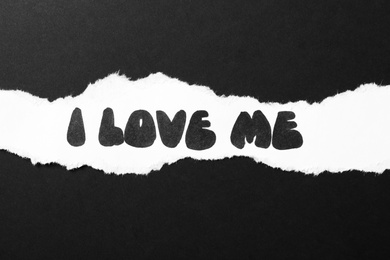 Photo of Piece of white paper with phrase I Love Me on black background, top view