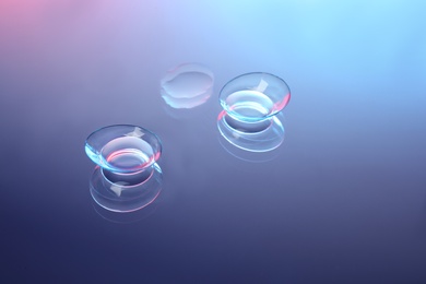 Contact lenses on color glass background