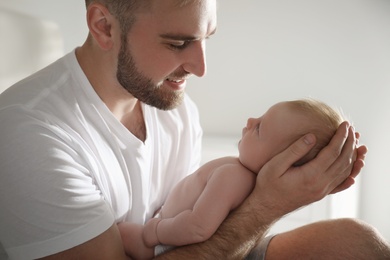 Photo of Father with his newborn son at home, closeup