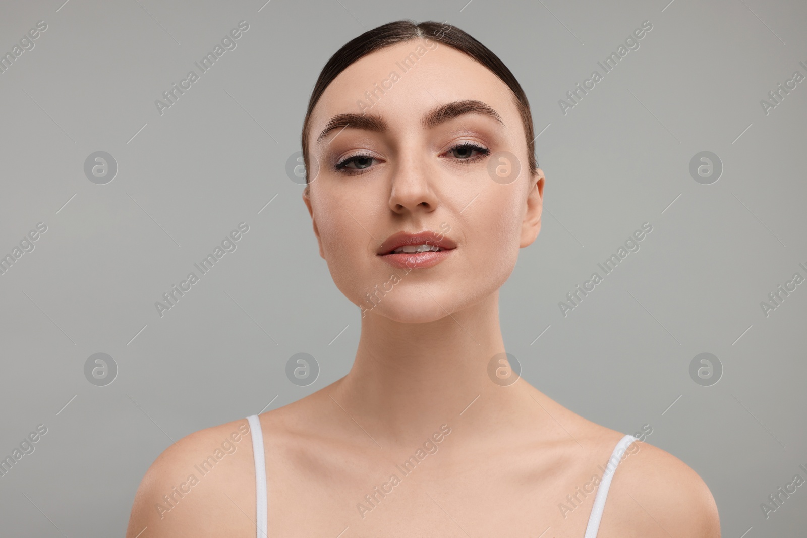 Photo of Portrait of beautiful woman on grey background