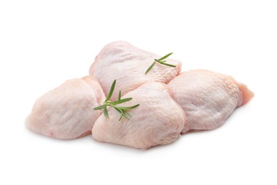 Raw chicken thighs with rosemary on white background