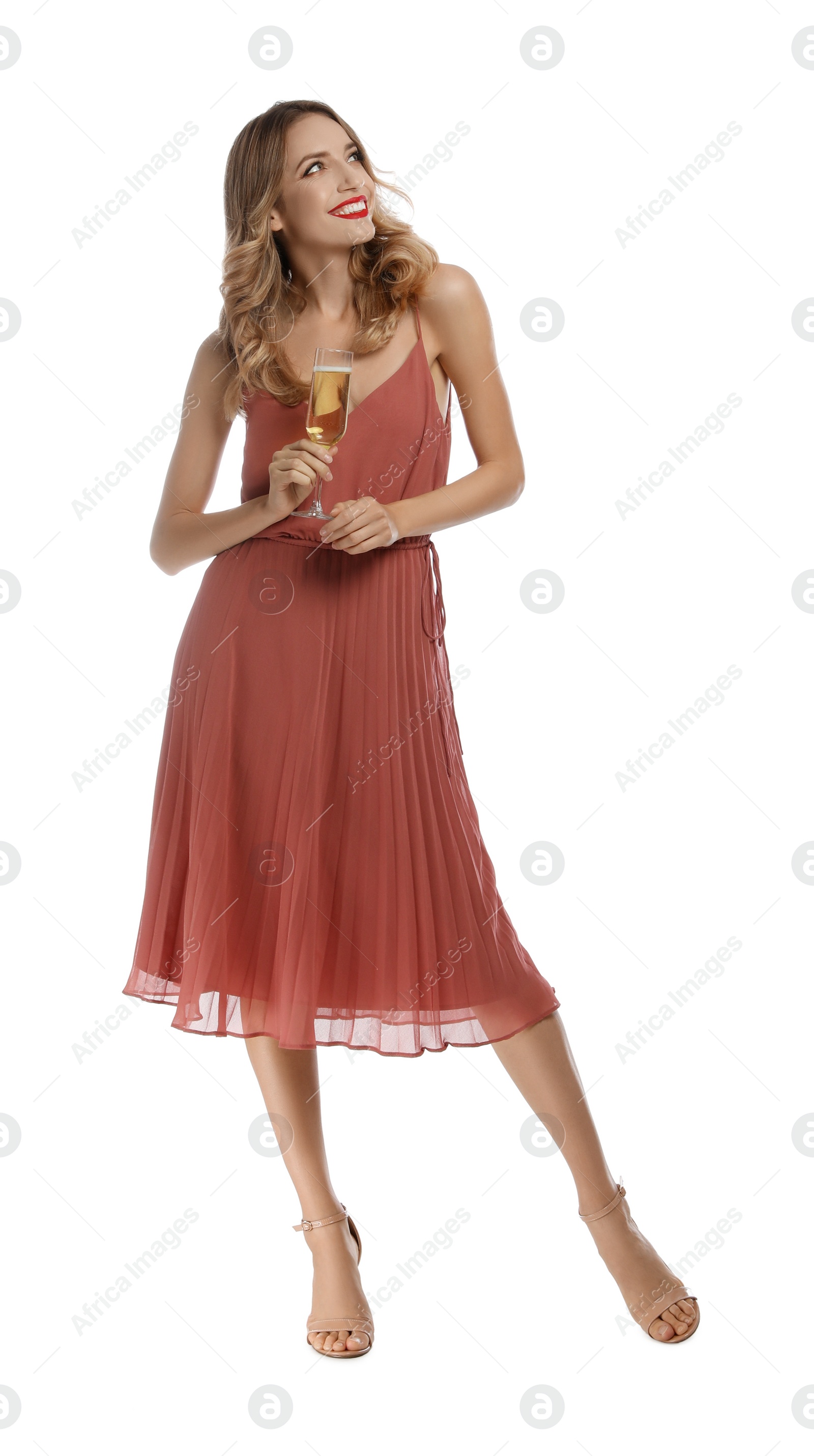 Photo of Happy young woman with glass of champagne on white background. Christmas celebration