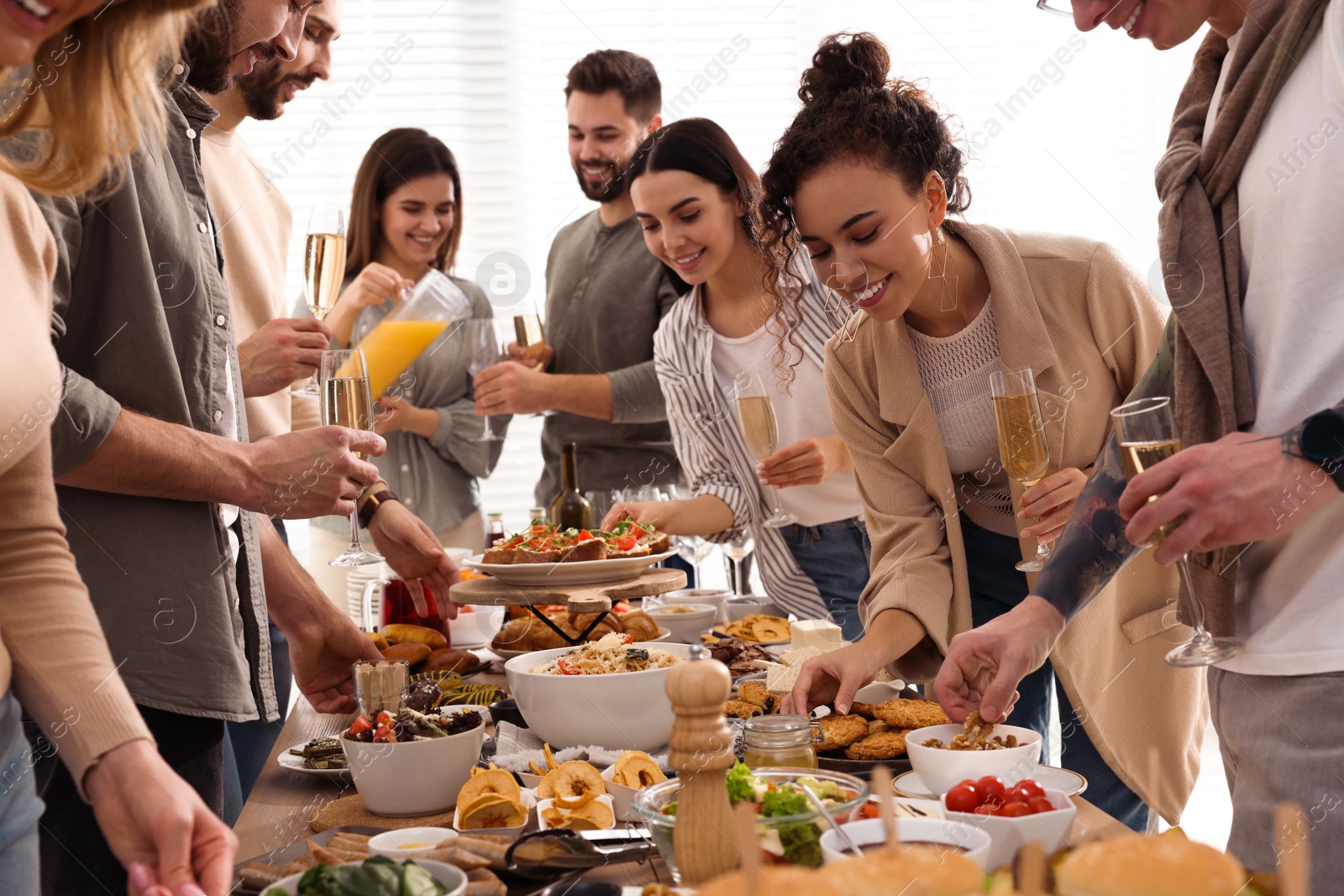 Photo of Group of people enjoying brunch buffet together indoors