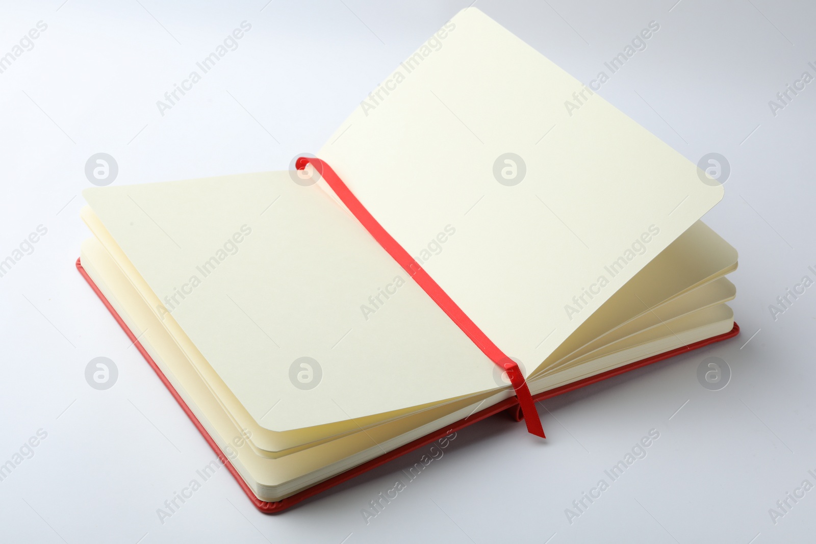 Photo of Stylish open notebook with blank sheets isolated on white