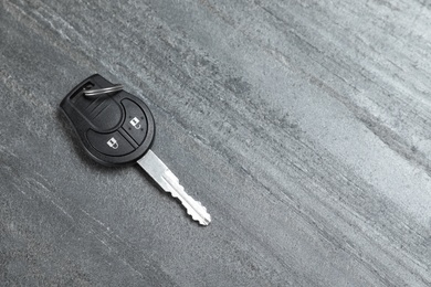 Photo of Car key on grey background, top view with space for text