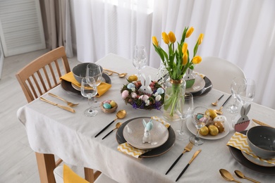 Photo of Beautiful Easter table setting with festive decor indoors