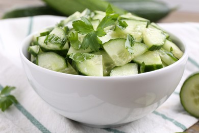 Photo of Delicious cucumber salad in bowl on table, closeup