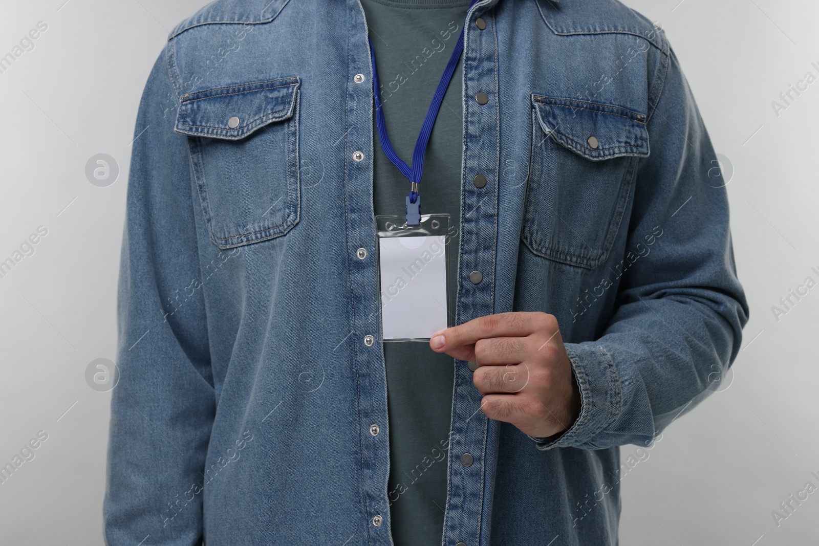 Photo of Man with blank badge on grey background, closeup