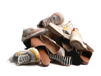 Photo of Pile of different shoes on white background