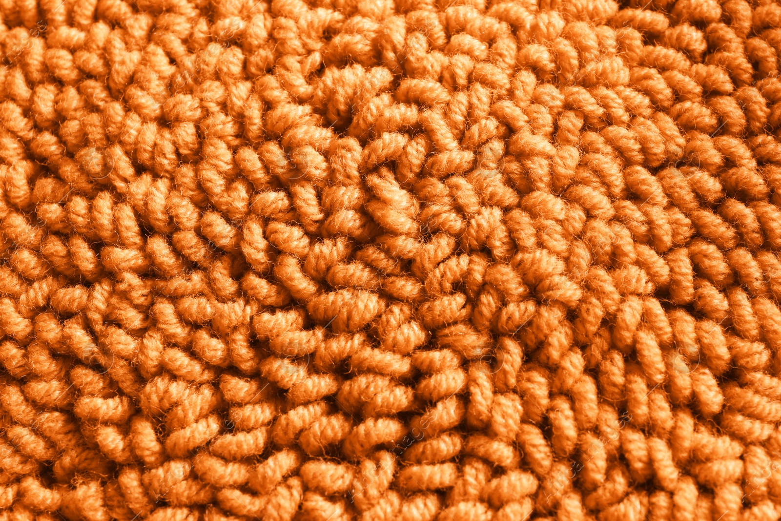 Photo of Orange woolen threads as background, top view