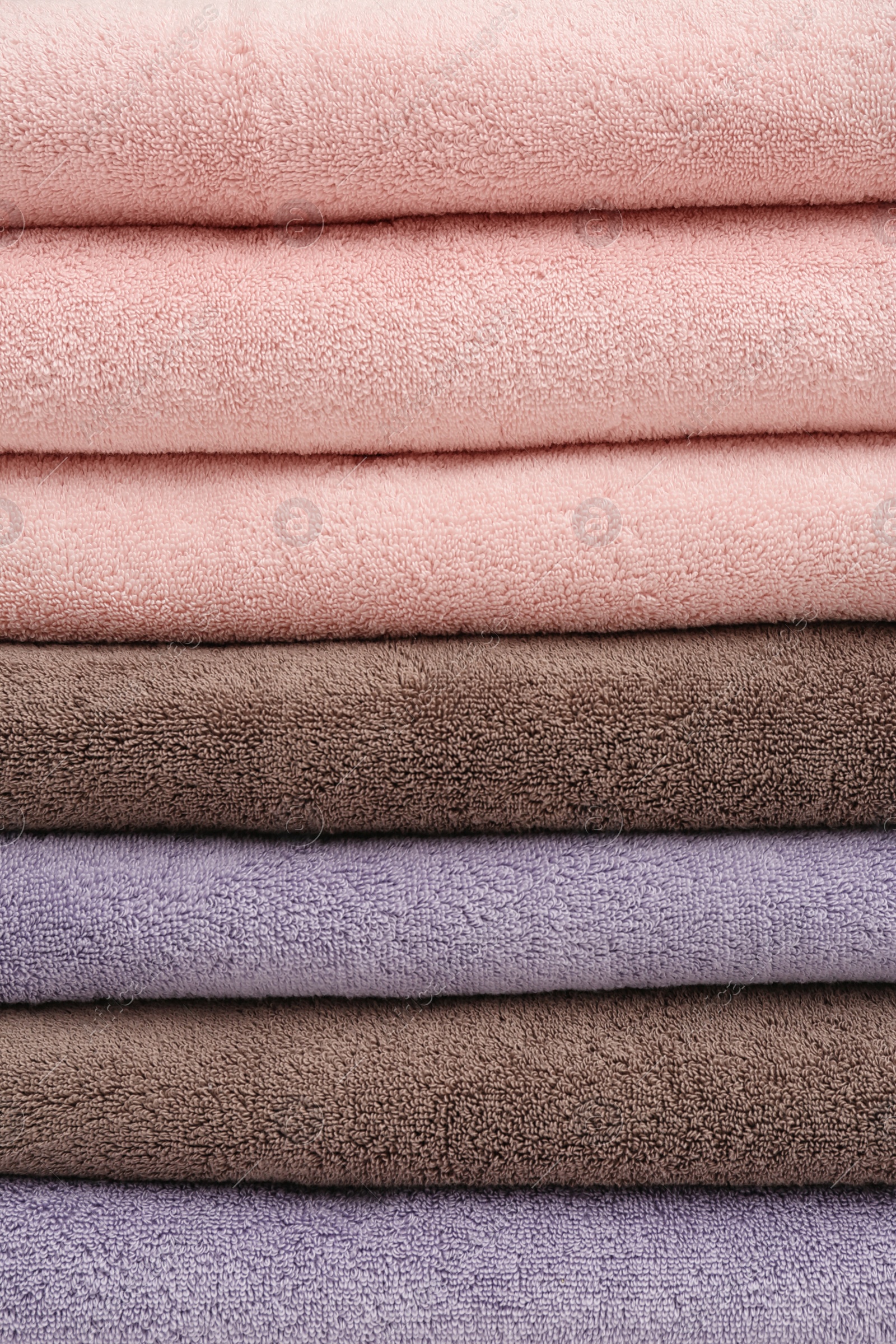 Photo of Stack of folded soft colorful towels as background