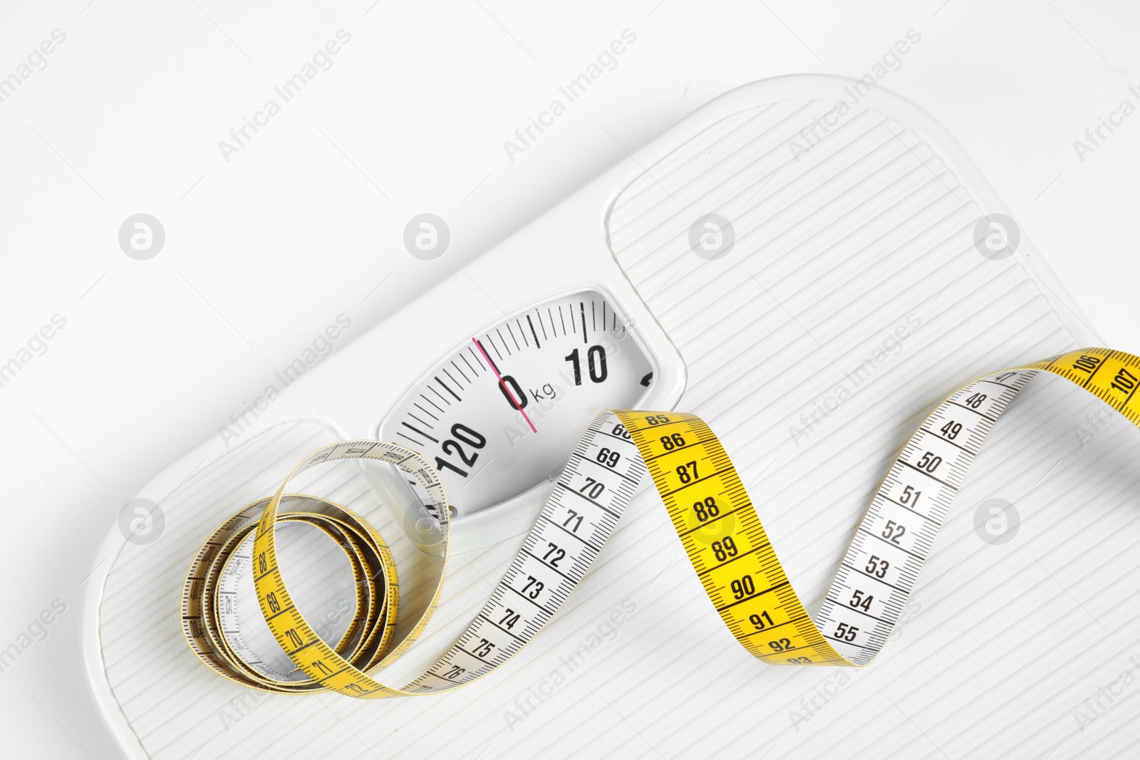 Photo of Modern scales and tape measure isolated on white, top view