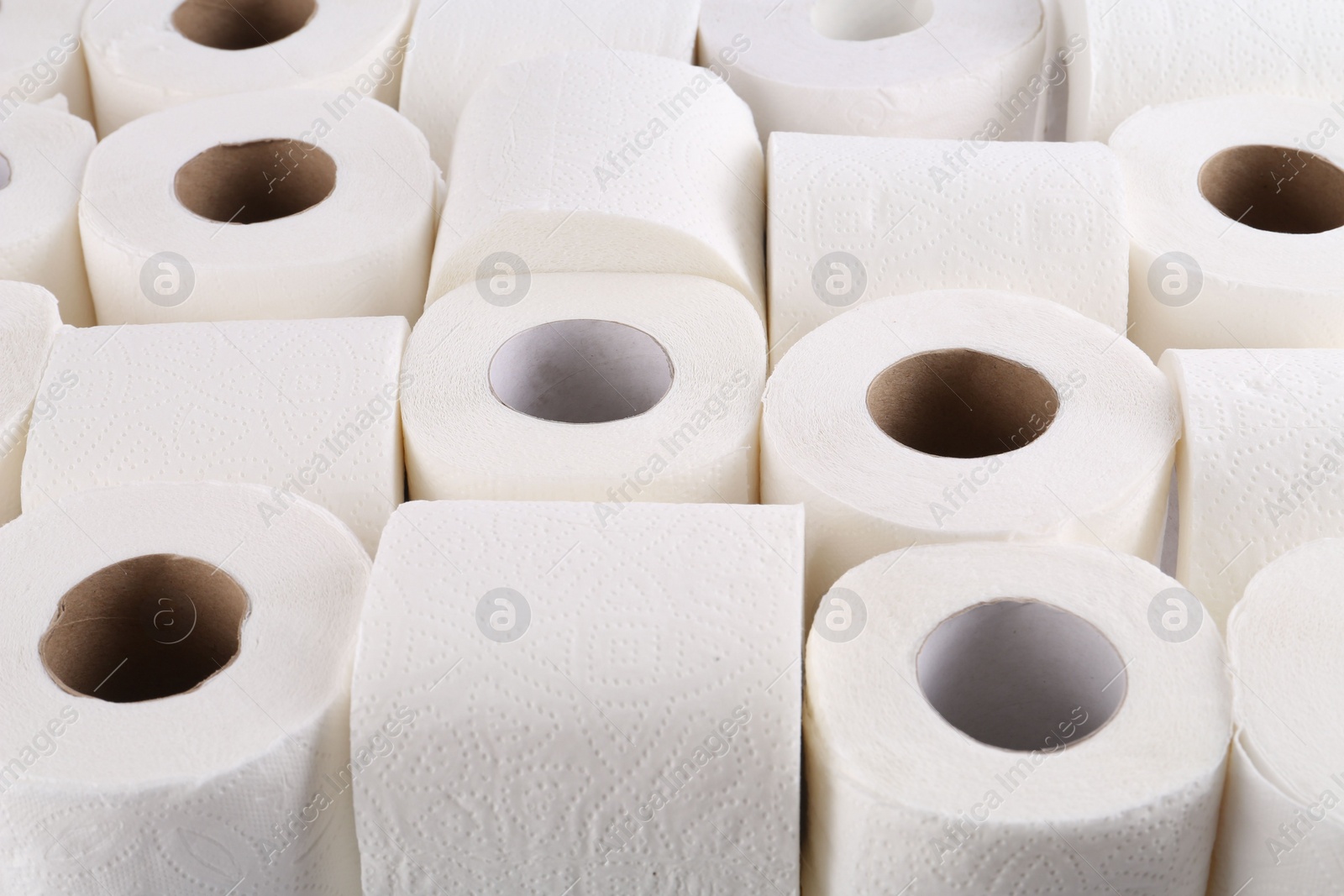 Photo of Many soft toilet paper rolls as background, closeup