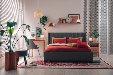 Photo of Stylish bedroom interior with comfortable bed and dressing table