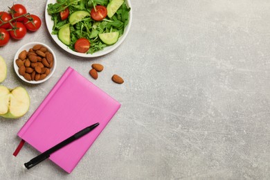 Photo of Weight loss concept. Flat lay composition with notebook, pen and different products on grey table, space for text