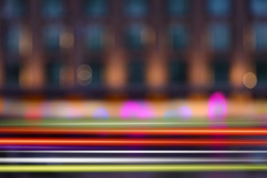 Image of Blurred view of building and light trails in city, motion blur effect