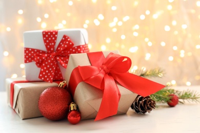 Photo of Christmas gifts and decoration on table against blurred background