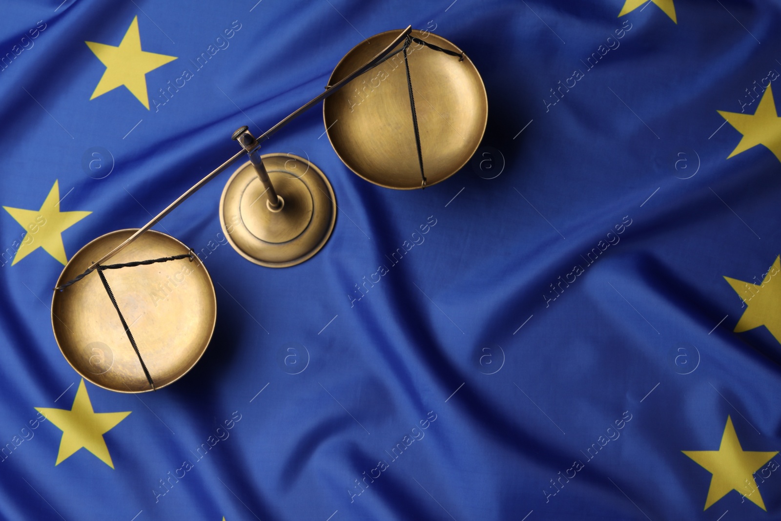 Photo of Justice scales on flag of European Union, top view. Space for text