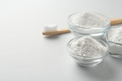 Photo of Tooth powder and brush on white background, space for text