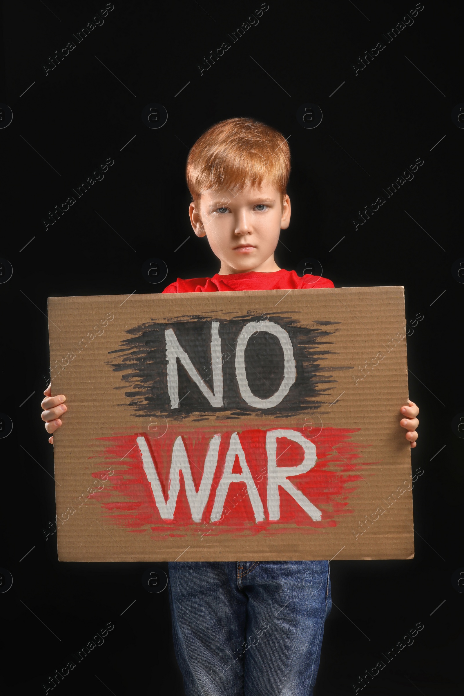 Photo of Boy holding poster No War against black background