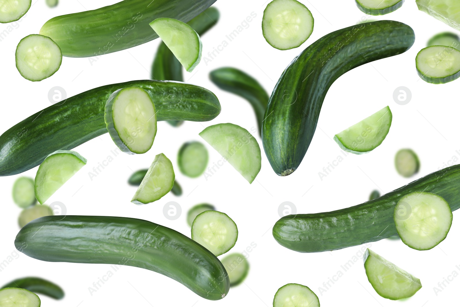 Image of Fresh green cucumbers falling on white background