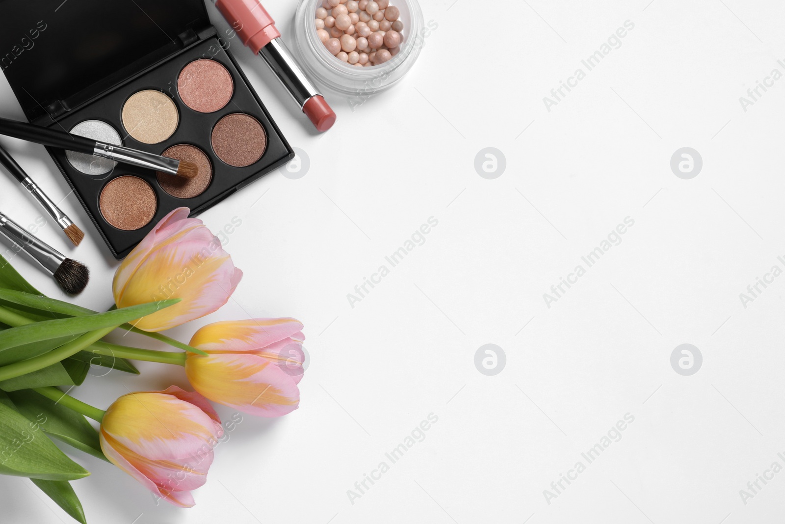 Photo of Flat lay composition with different makeup products and beautiful tulips on white background, space for text