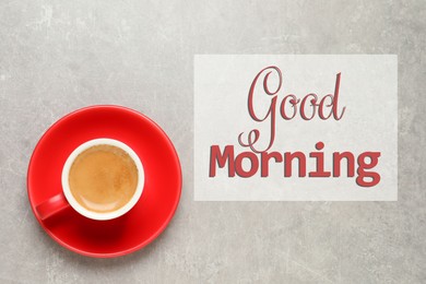 Image of Good Morning. Aromatic coffee in red cup on light grey background, top view