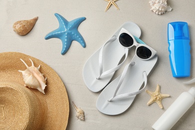 Flat lay composition with beach accessories on sand