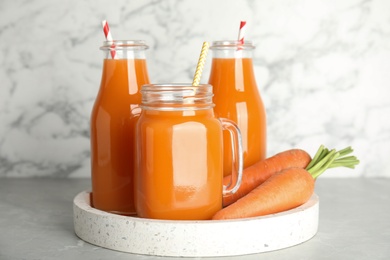 Freshly made carrot juice on white table