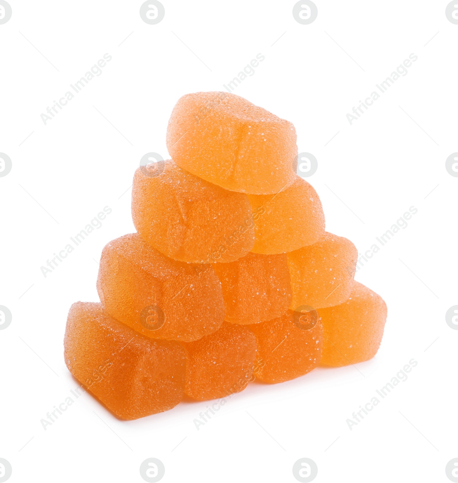 Photo of Pyramid made with tasty orange jelly candies on white background