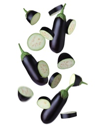 Image of Cut and whole eggplants falling on white background